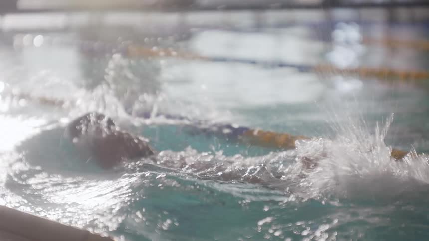 Person swimming in a lane in the pool