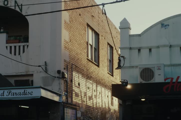 A sunlit corner of the brick facade on a building