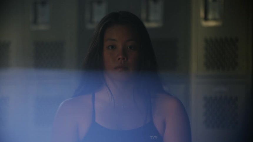 A swimmer is in the locker room
