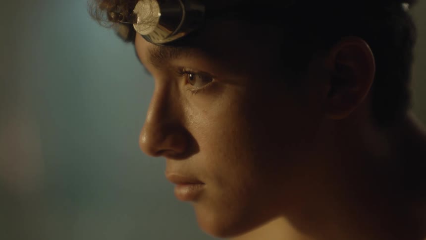 A teenager slowly lifts his head up