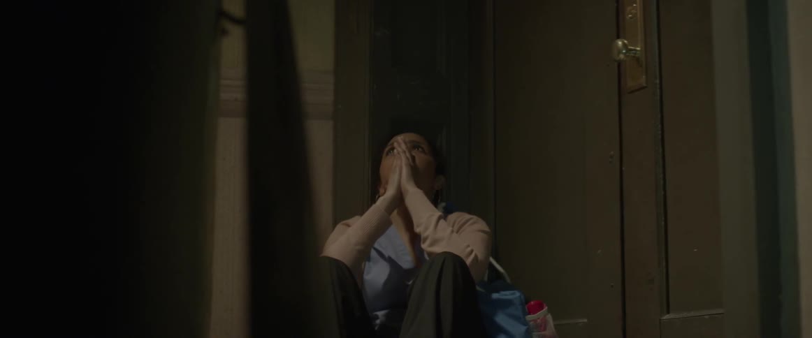A woman falls to the floor seemingly overwhelmed