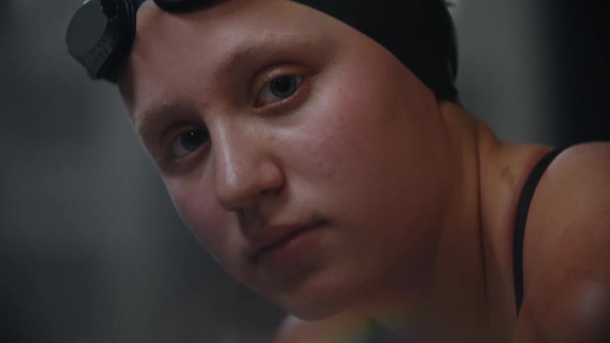 Portrait of a young woman with swimming cap and goggles