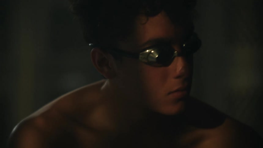 Portrait of a concentrated young man without a shirt and wearing swimming goggles