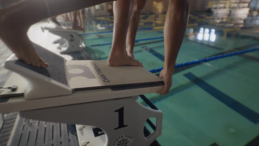 Group of people jumping into the pool at the same time