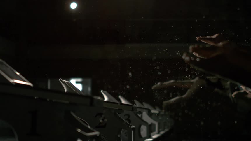 Silhouette of female swimmers jumping at the same time into the pool