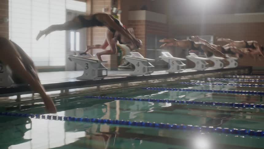 Swimmers race in the pool
