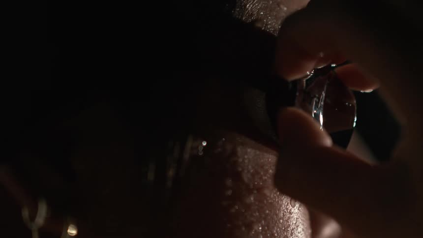Closeup of a swimmers face still wet from swimming as she takes off her swimming goggles