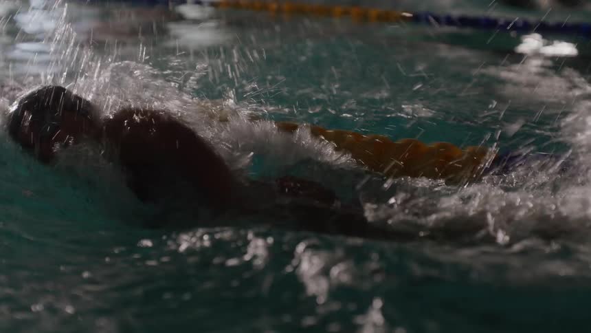 A swimmer races in the pool