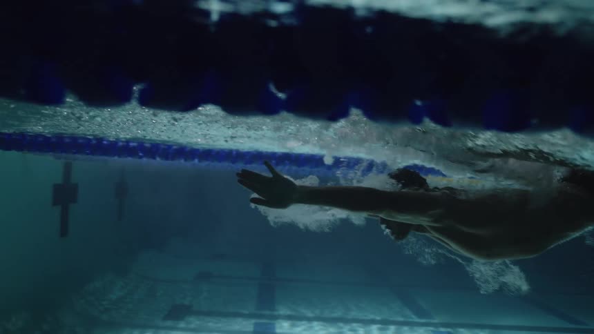 Man swimming in a lane in the pool
