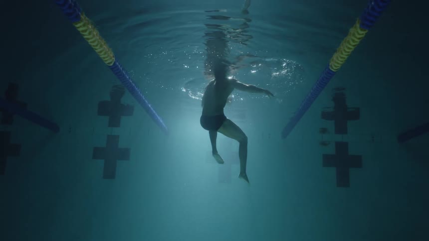 Person swimming in deep pool