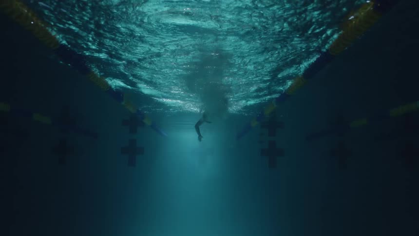 A man is swimming in the pool