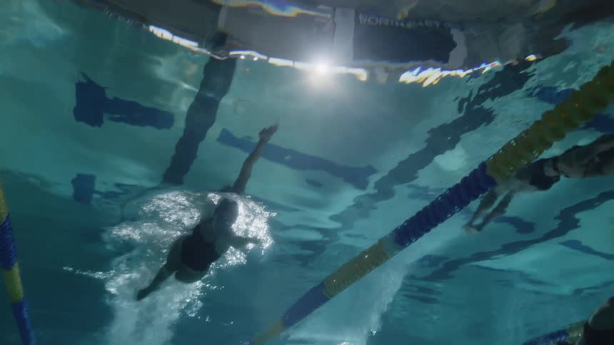 Female swimmers in action underwater in the pool