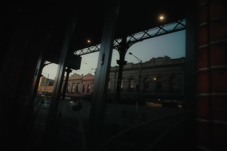 A car drives past the buildings