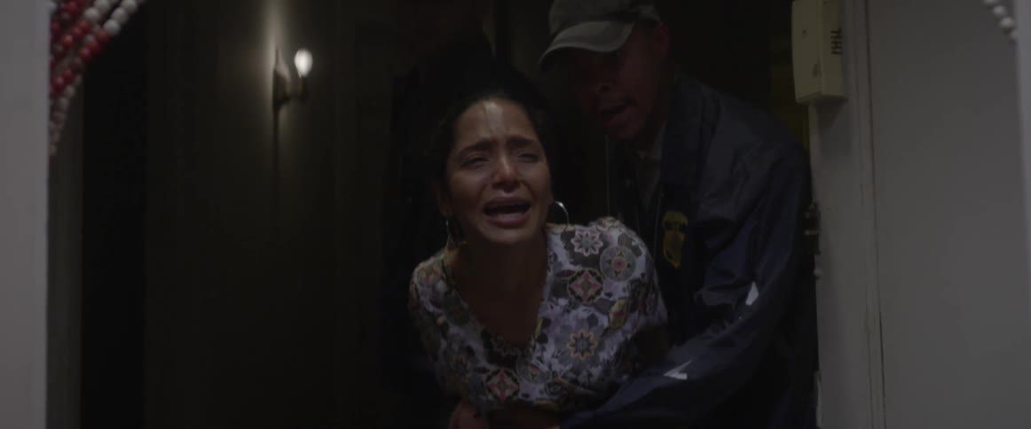 Woman crying as she is being arrested in her home