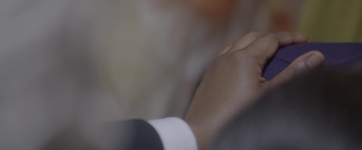 A woman lays her hand on someone's shoulder