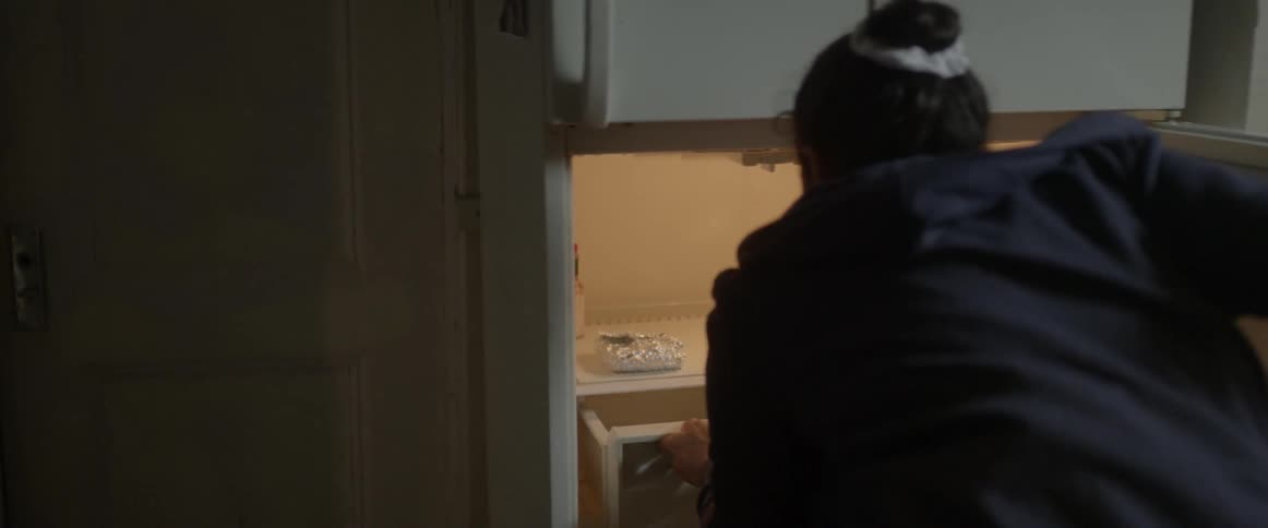 Woman looking into an empty kitchen drawer