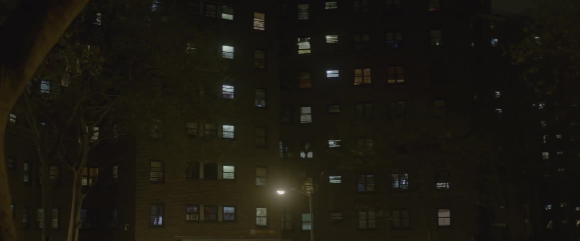 The building has many lit windows at night