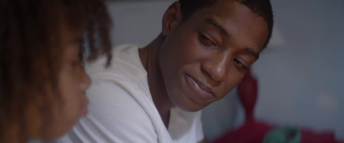 A boy looks towards his sister and smiles