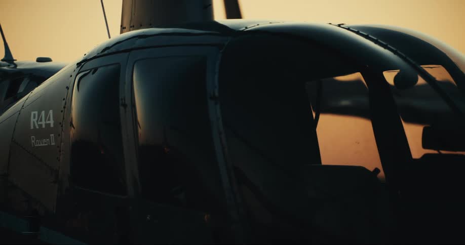 Setting sun shines through the gap between two parked aircraft