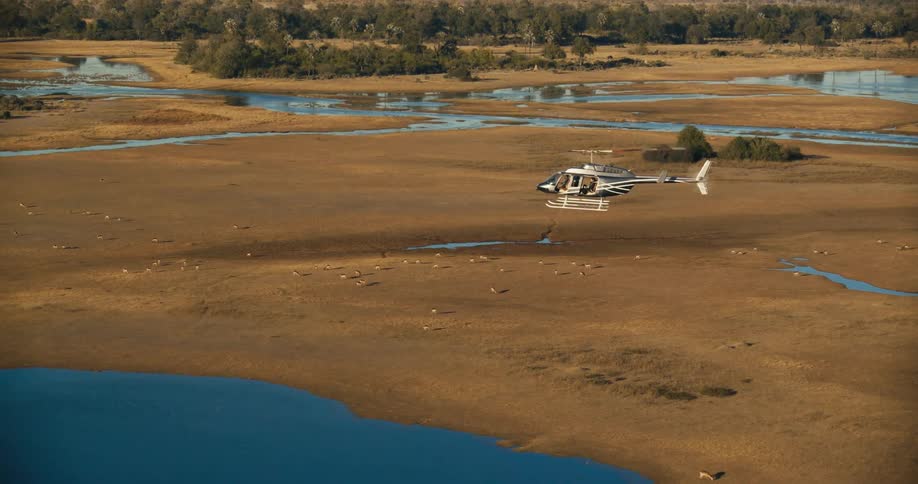 Panorama from a helicopter flying above a jungle with forest and lakes