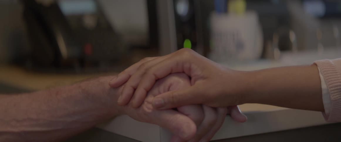 A woman grabs a man's hand