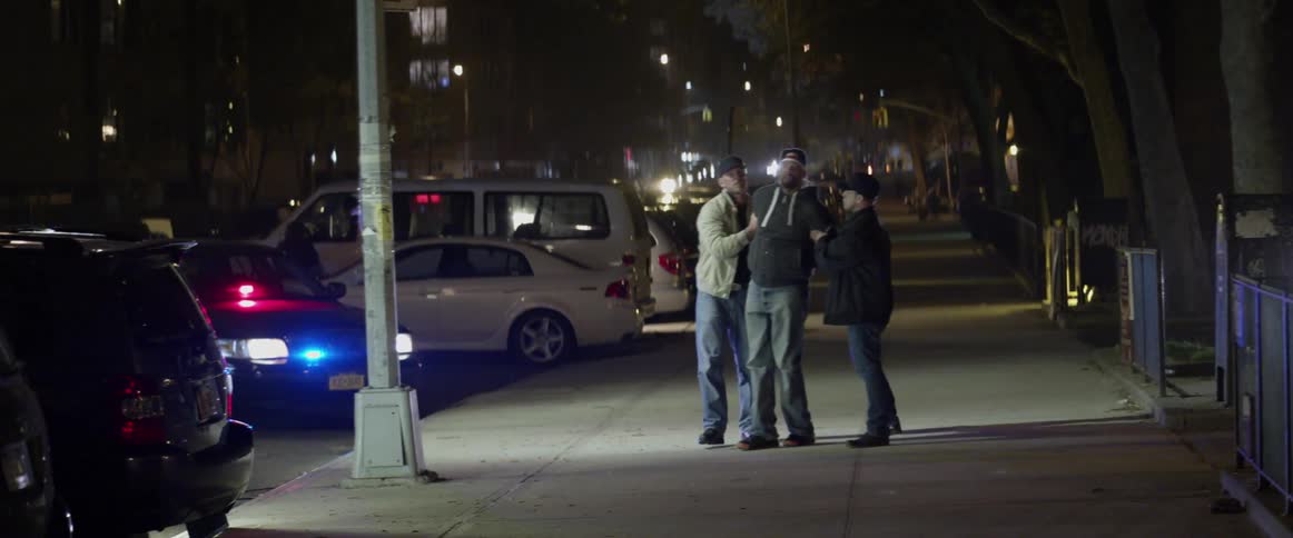 Man being arrested by two undercover cops at night