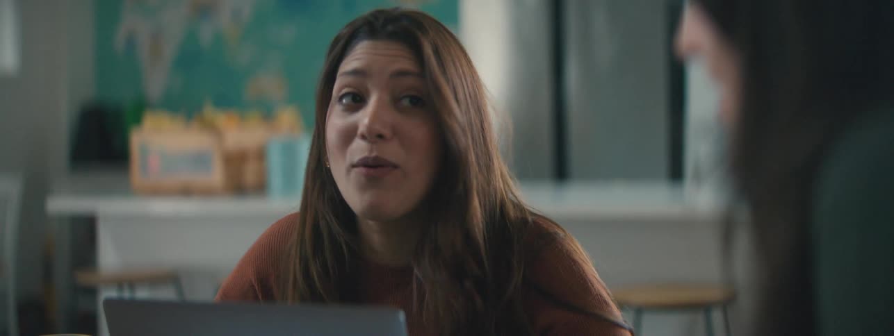 A woman is talking and smiling