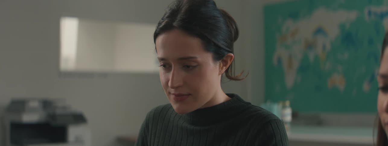 Black haired woman sitting concentrated