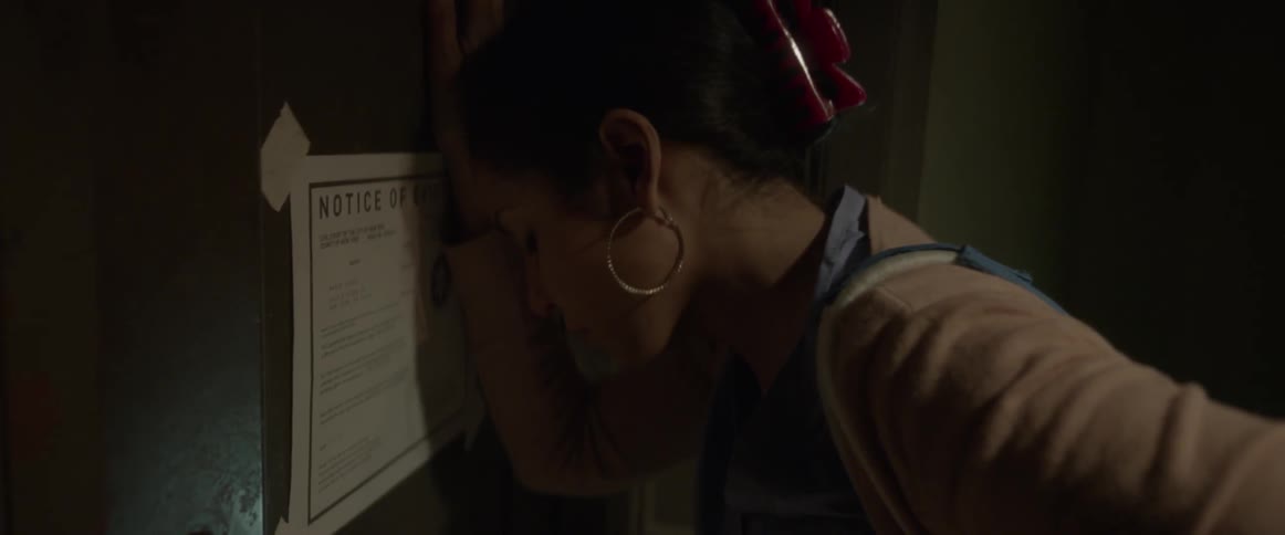 A woman bangs her head against a door