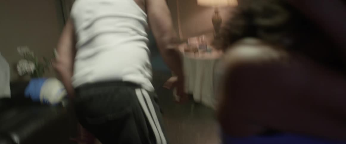 An angry man throws a bottle while arguing with a woman