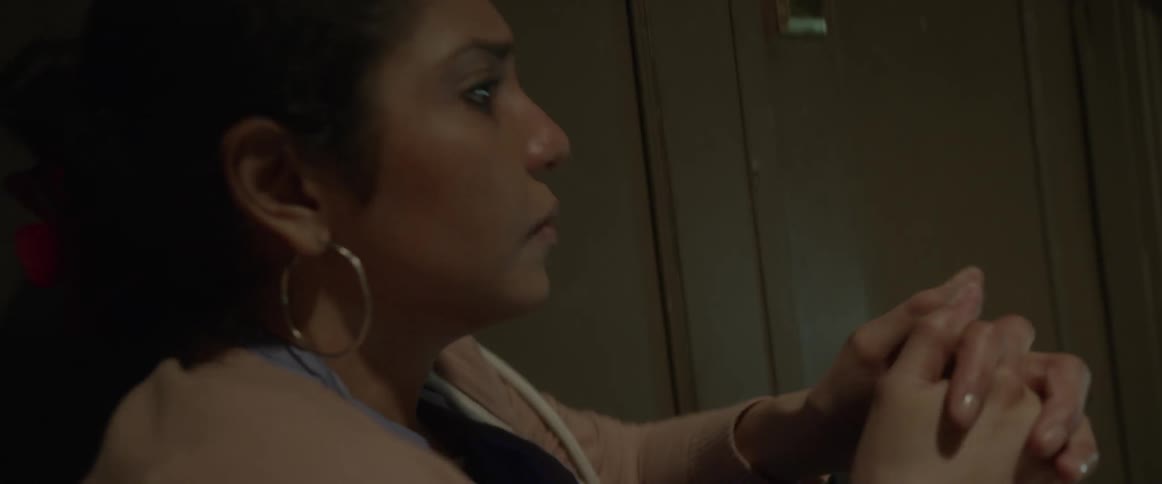 A woman rubs her head and contemplates things