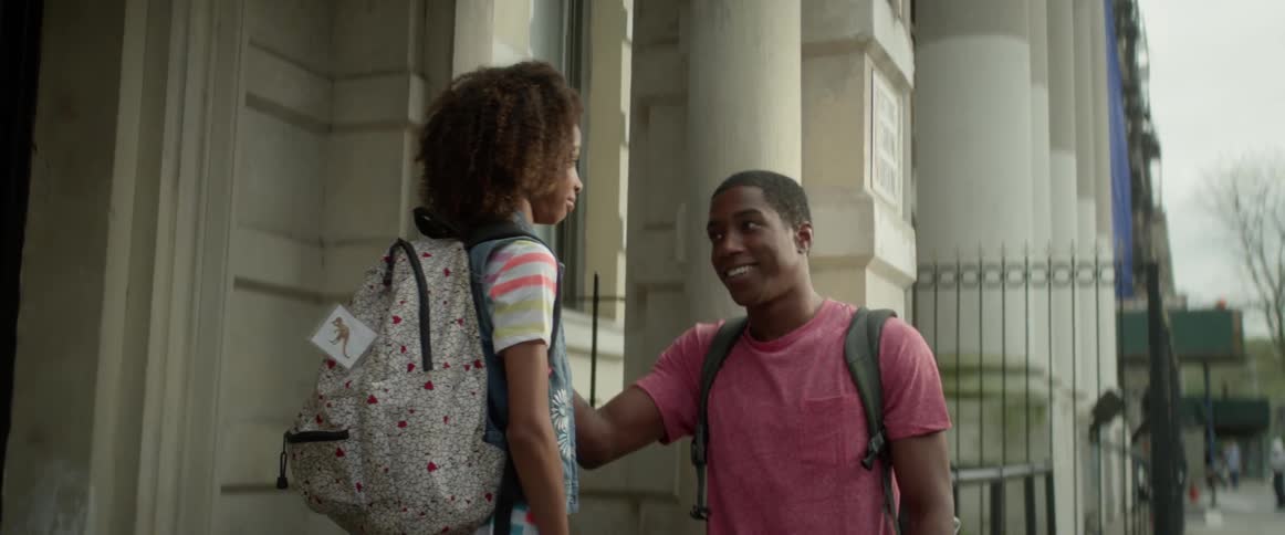 A teenager and young girl leave an apartment with backpacks