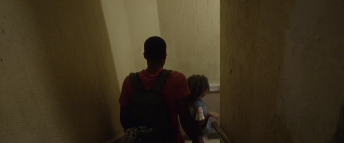 Two kids walk down an apartment staircase