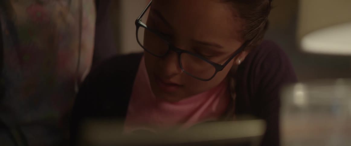 A woman helps her daughter with homework