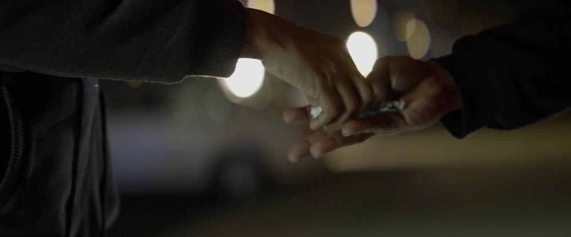 A drug deal takes place at night