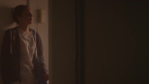 Woman walks in her home looking troubled
