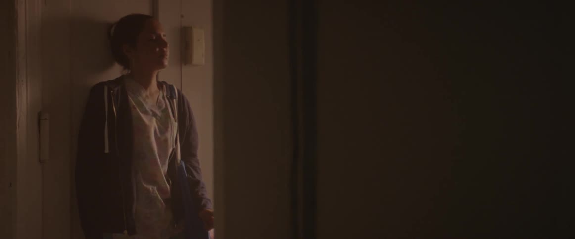 Woman walks in her home looking troubled