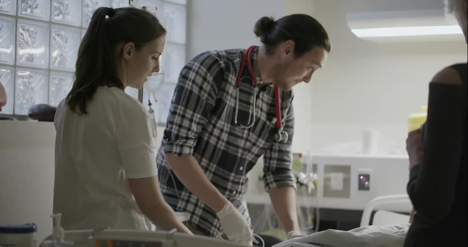 A doctor and nurse tend to a patient