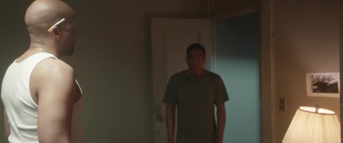 A man is yelling at a younger man in a home