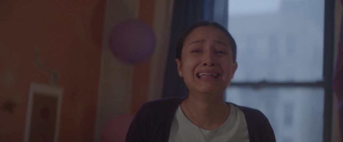 A girl in a room gets up and cries and screams