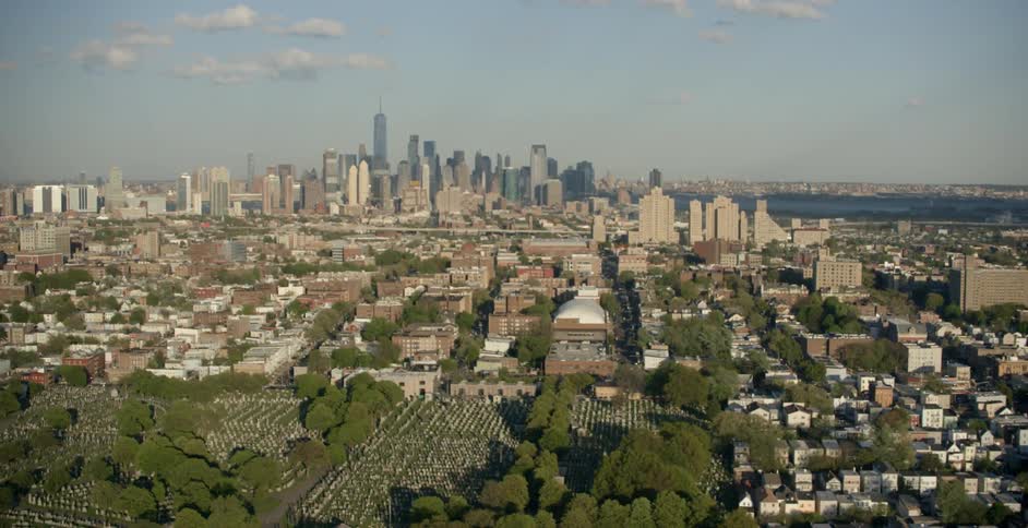 A suburb with the city in the distance being filmed from the sky