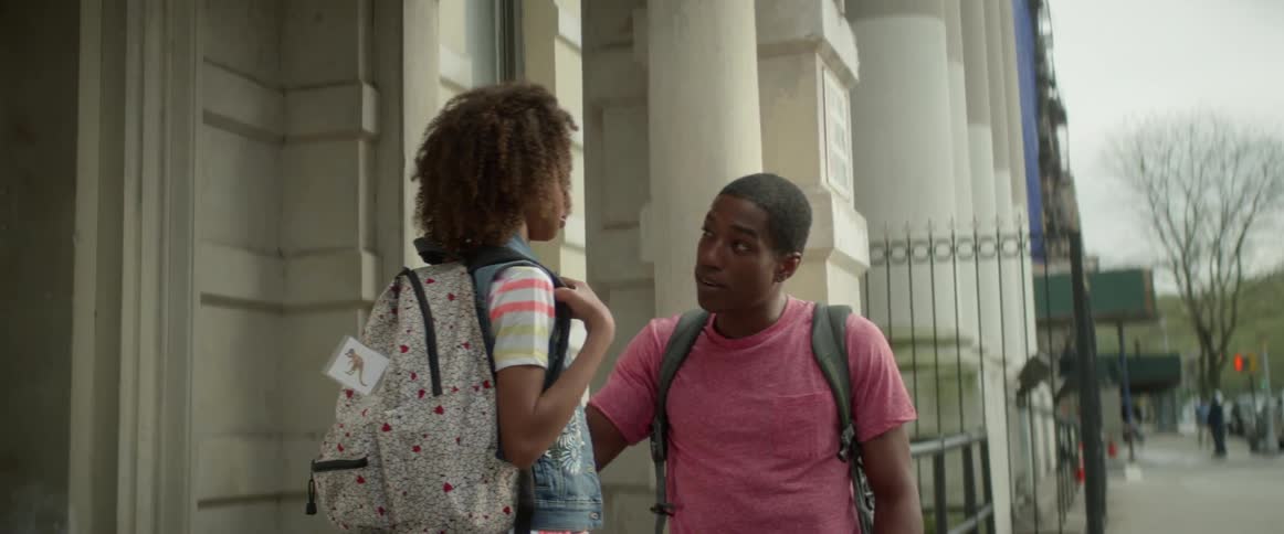 A boy and a girl with backpacks on talking
