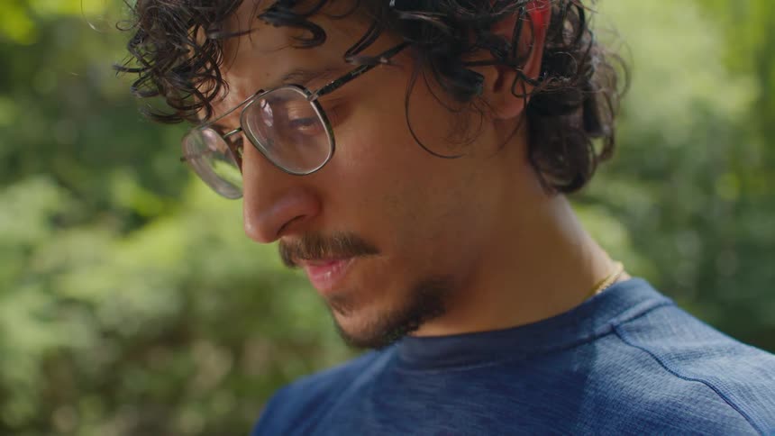 Portrait of a man wearing glasses in a focused outdoor setting