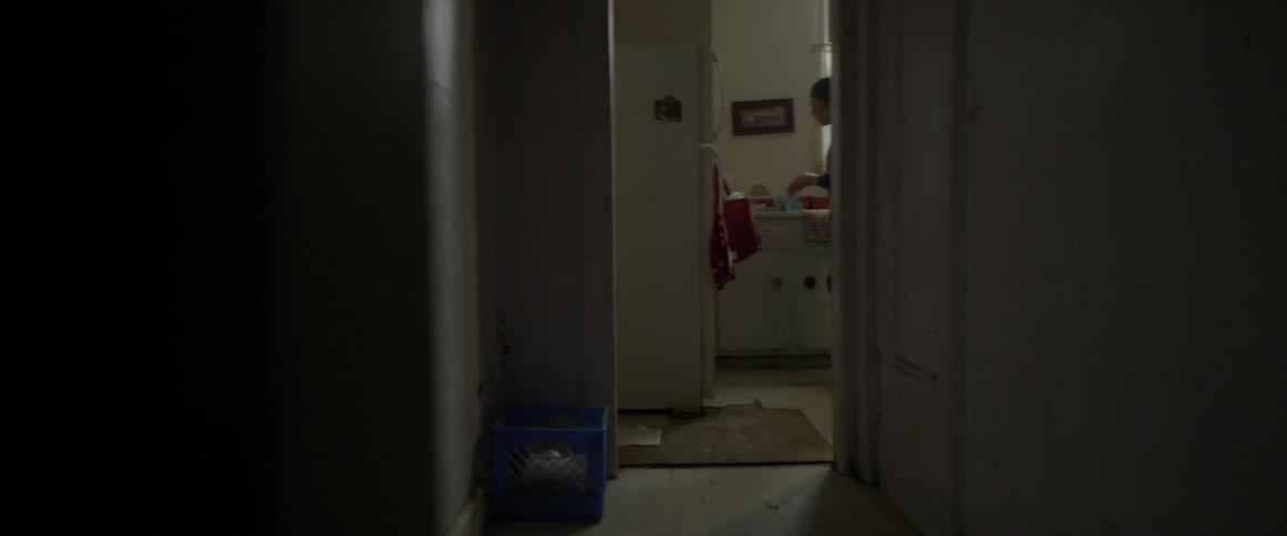 A woman opens her refrigerator