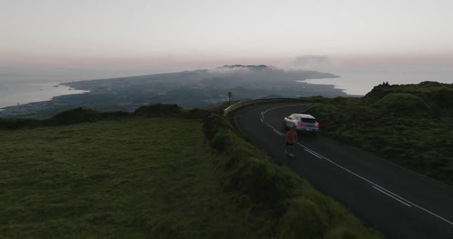 Person skateboarding on a mountainous road