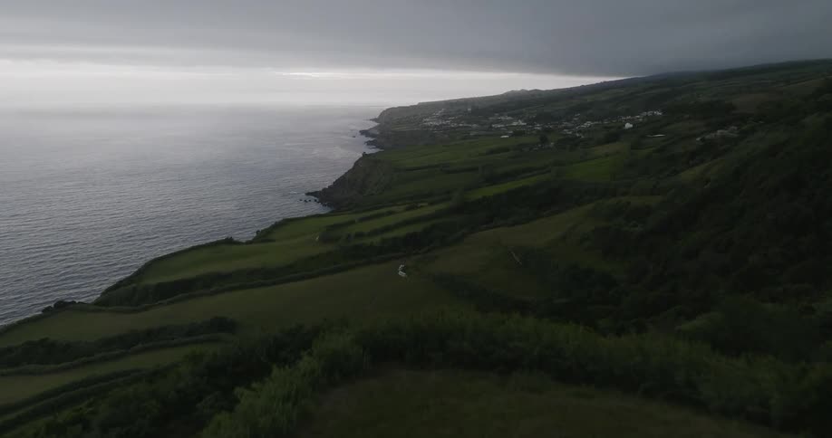 Landscape of a vast mountain surrounded by the sea on a cloudy day