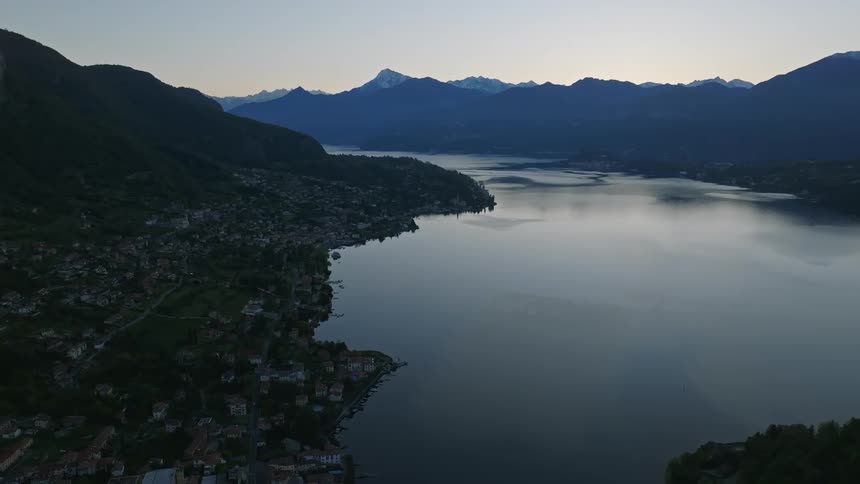 A coastal town nestled at the foot of a mountain range
