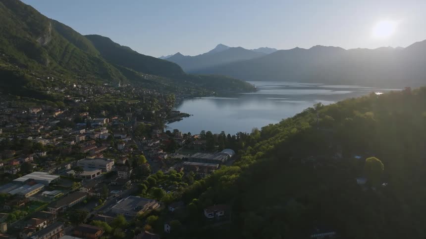 Aerial view of a community surrounded by mountains and on the edge of a lake
