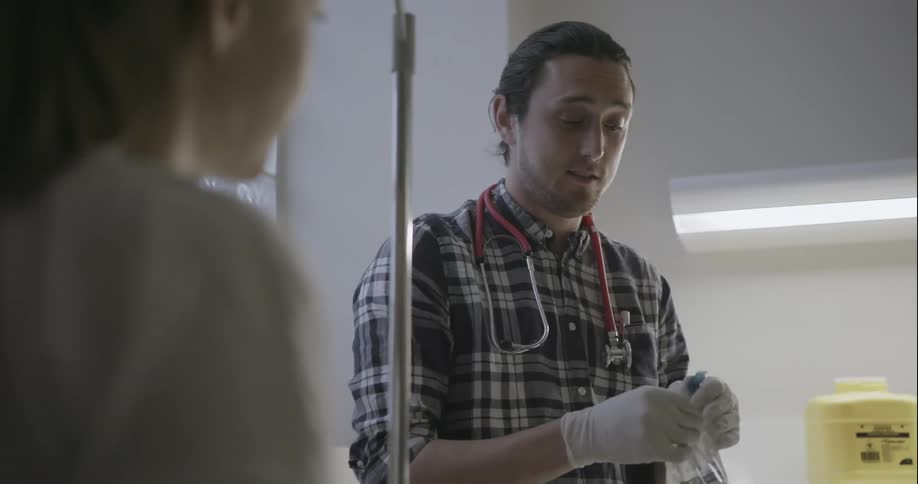 A doctor handles an iv bag