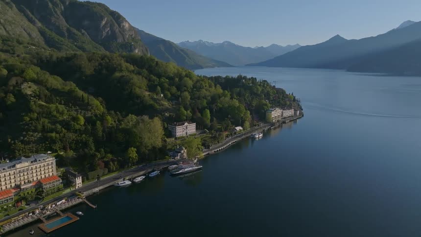 A serene lake with a small town and villas nestled along the shoreline